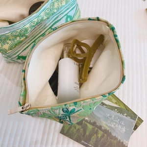 Green jacquard floral makeup bag with metal zipper and travel toiletries storage