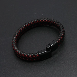 Dettaglio del bracciale in pelle intrecciata rossa e nera con chiusura magnetica