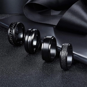 Set of 4 black titanium rotating rings with chain, brushed, and frosted textures
