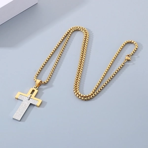 Two-tone stainless steel cross pendant with scripture engraving on a gold box chain
