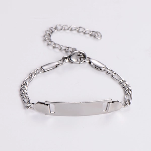 Close-up of Figaro chain with a blank rectangular metal plate for custom engraving