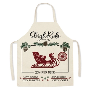 Detail of linen Christmas apron with vintage sleigh ride text and festive beige pattern