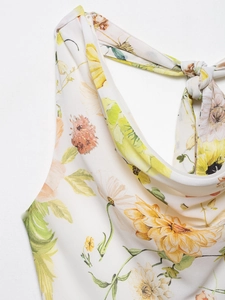 Detail of the cowl neck and delicate floral print on a white summer halter top