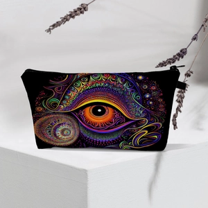 Detail of waterproof travel pouch with vibrant evil eye pattern on white geometric stand