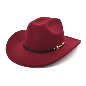 Close-up of wine red jazz fedora hat with brown leather band and golden metal buckle
