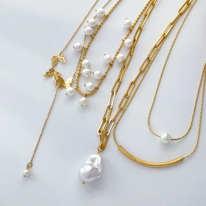 Double-layered butterfly pendant necklace with pearls and tassel in polished gold finish