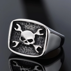 Punk rocker stainless steel ring with 3D skull and crossed wrench design on black background