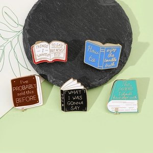 Detailed view of five creative enamel book pins with motivational English quotes