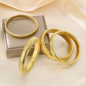 Detailed view of golden textured stretch bracelet with vertical stripe pattern design