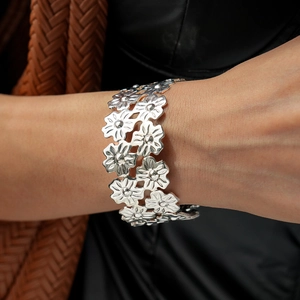 Detail of silver floral multi-layer open cuff bracelet with brushed metallic finish