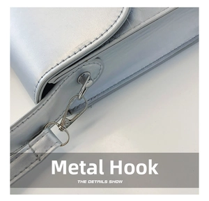 Detail of silver matte leather bag showing high-quality metal lobster clasp and stitching