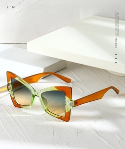 Detailed macro view of geometric cat-eye sunglasses with colorful translucent frames