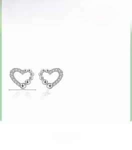 Detail view of 925 sterling silver hollow heart earrings with cubic zirconia stones