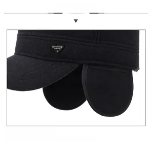 Detailed close-up of winter thermal earflap hat with metallic triangle logo and warm lining