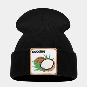 Close-up of the black knit beanie featuring a coconut embroidery patch and text detail