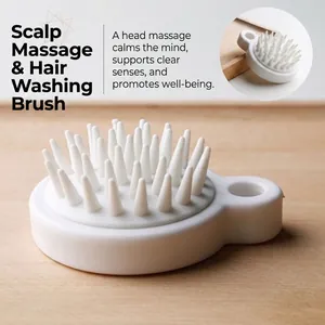 Japanese style white silicone scalp massage brush with soft bristles and finger grip handle