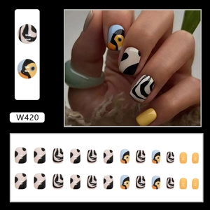 Detail view of W420 press-on nails set with toucan motifs and zebra patterns
