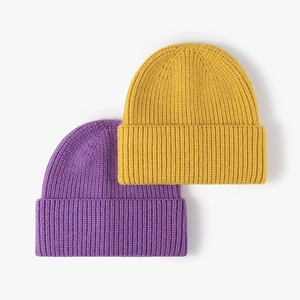 Classic rib-knit winter beanies in purple and yellow colors with wide folded cuffs