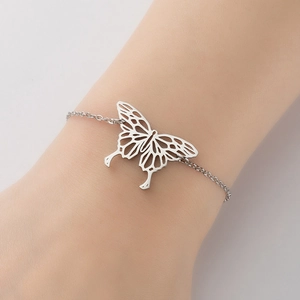 Elegant stainless steel bracelet with a hollow butterfly pendant worn on a female wrist