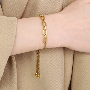 Detail view of a gold geometric chain link bracelet with adjustable drawstring closure