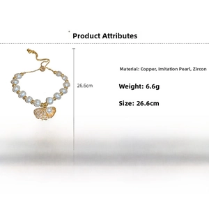 Detail view of irregular pearl bracelet with shell pendant and zircon stones