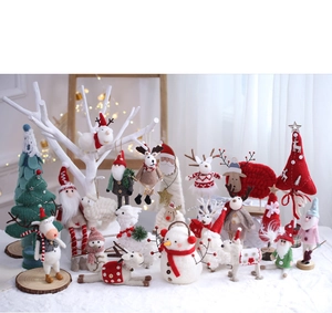 Detail of wool felt Christmas decorations with Santa, elk, and snowman on wooden bases