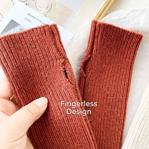 Knitted fingerless gloves in caramel brown featuring thumb hole and vertical ribbed texture