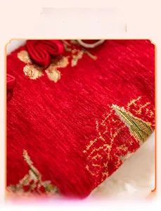 Macro shot of red chenille fabric with detailed traditional Chinese gold embroidery