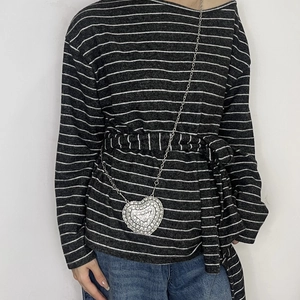 Detailed view of the oversized silver heart necklace with sparkling rhinestone inlay