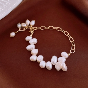 Baroque freshwater pearl and gold plated chain bracelet on a brown silk background