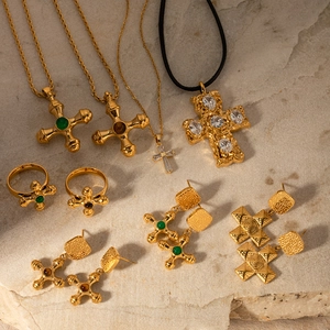 Detailed flat lay of 18K gold plated stainless steel cross necklaces and jewelry set