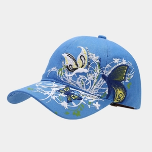 Detail of sky blue baseball cap featuring intricate butterfly sequin embroidery on the side