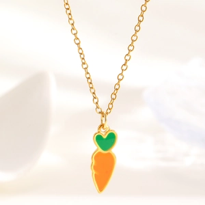 Detailed view of a sweet carrot shaped pendant necklace with vibrant orange and green enamel