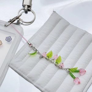 Handmade cherry phone charm with pink heart beads and green leaves on silver chain