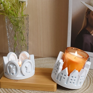 Detail view of rabbit and house shaped candle holders in a cozy minimalist home setting