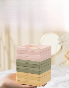 Stackable jewelry boxes with PE film in pastel colors shown held in a vertical pile