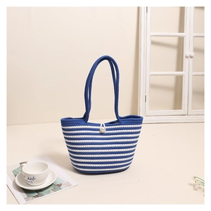 Detail of blue and white striped woven beach bag with blue handle and pearl buckle