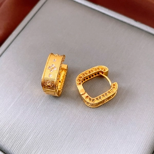 Detailed view of vintage gold zircon square hoop earrings with hollow patterns on gray velvet