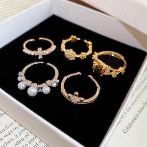 Detail view of 5-piece ring set with pearls and zircon in a black velvet jewelry box