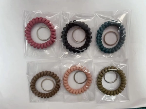 Detailed view of colorful spiral spring keychains in assorted colors with metal rings