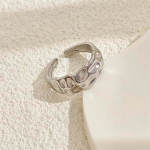 Macro view of silver adjustable ring with unique hammered texture on stainless steel