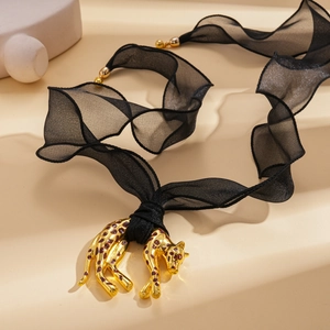 Golden leopard pendant necklace with wide black organza ribbon for a bold fashion look
