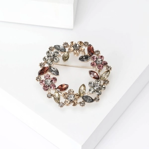 Macro shot of circular wreath brooch with multi-colored crystals and rhinestones