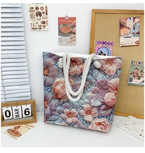 Close-up of floral embroidered canvas tote bag with nautical rope handles in a lifestyle setting