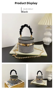 Macro view of silver rhinestone cylinder bag with black pleated handle and gold clasp