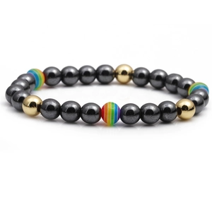 Men's hematite beaded bracelet with golden and rainbow accents on white background