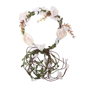 Bohemian floral crown with cream silk flowers and green leaves on a vine headband