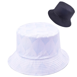 Detail of light blue wavy pattern bucket hat and solid black reversible sun hat