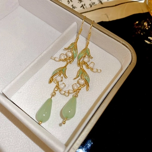 Detailed view of lily of the valley earrings with green resin drops and pearls