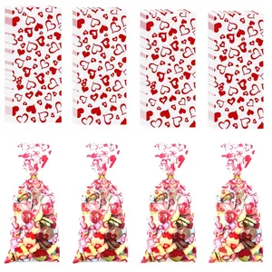 Detail of red heart printed cellophane bags with golden twist ties and candy fillings